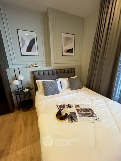 Cozy bedroom with modern decor, featuring a comfortable bed, stylish artwork, and elegant lighting.