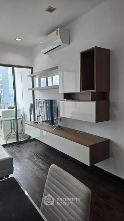 Modern living room with sleek furniture and balcony view in urban apartment