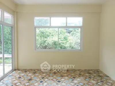 Bright room with large windows and colorful tiled floor, perfect for creative interior design.