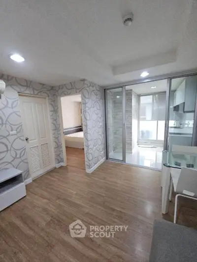 Modern apartment interior with wooden flooring and stylish wallpaper