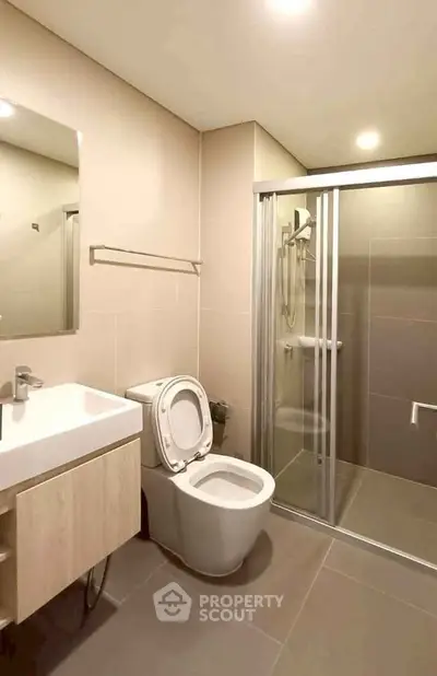 Modern bathroom with sleek fixtures and glass shower enclosure