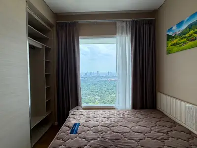 Cozy bedroom with stunning city view and ample closet space in modern apartment.