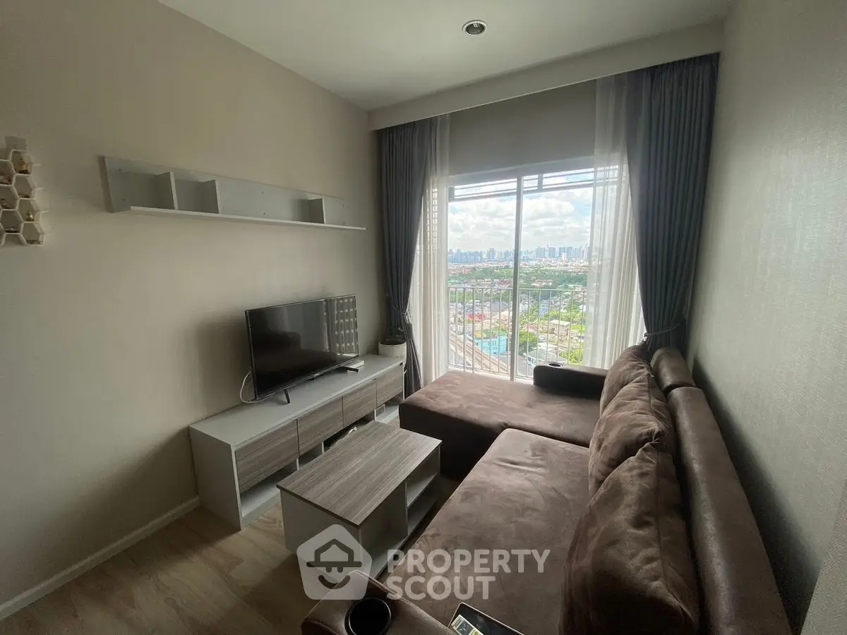 Cozy living room with large window offering stunning city view
