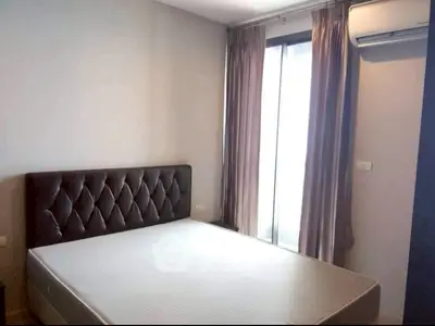 Cozy bedroom with natural light and modern air conditioning unit.