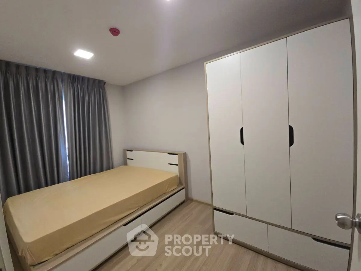 Modern bedroom with sleek wardrobe and cozy bed in minimalist design