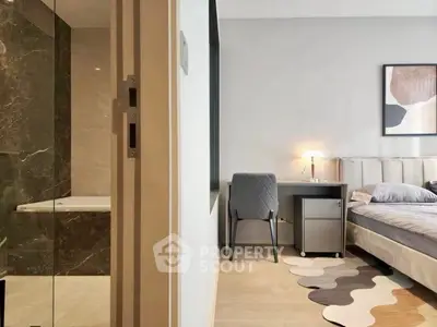 Modern bedroom with ensuite bathroom featuring elegant decor and stylish furniture.