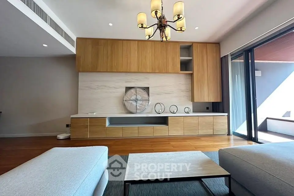 Luxurious modern living room with elegant chandelier and spacious design