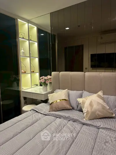 Luxurious bedroom with elegant decor and plush bedding in modern apartment.