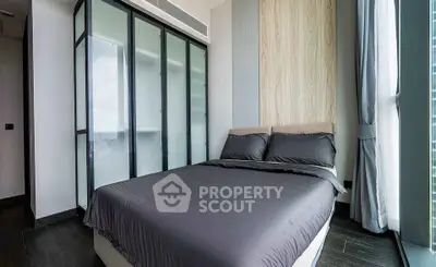 Modern bedroom with sleek design and large windows offering natural light