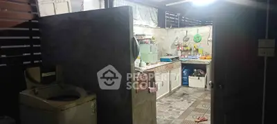 Cozy kitchen with washing machine and rustic decor, perfect for practical living.