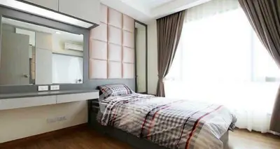 Modern bedroom with stylish decor and large window for natural light