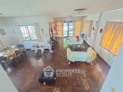 Spacious living room with wooden flooring and natural light