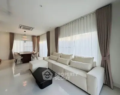 Spacious modern living room with elegant dining area and natural light