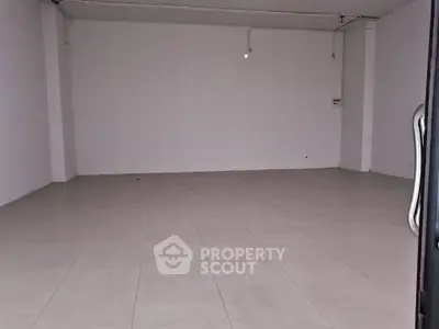 Spacious empty room with tiled flooring ideal for customization
