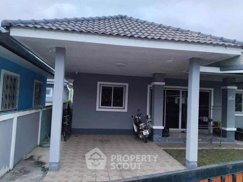 Charming single-story home with covered carport and tiled roof, ideal for comfortable suburban living.