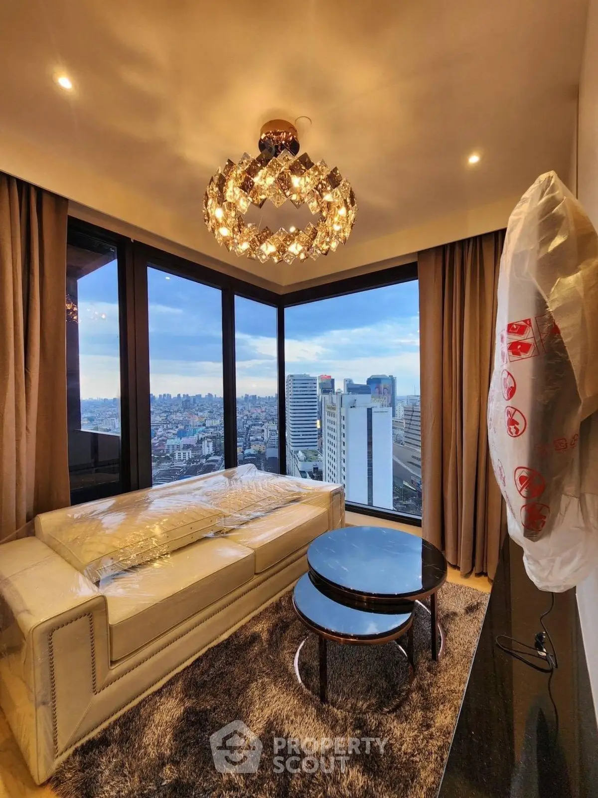 Luxurious living room with panoramic city view and elegant chandelier