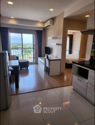 Modern open-plan living room with balcony view in a stylish apartment