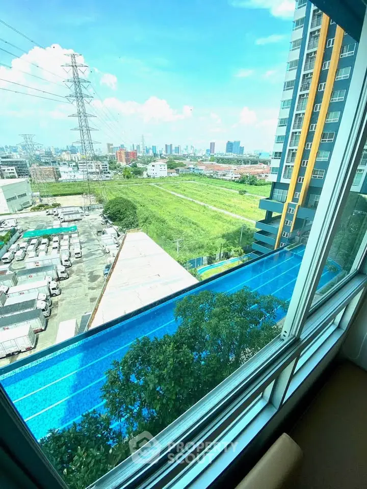 Stunning high-rise apartment view with pool and cityscape backdrop