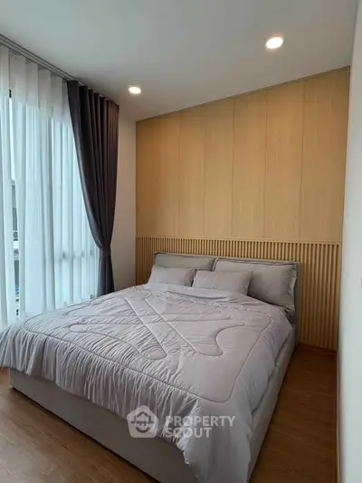 Modern bedroom with cozy bedding and elegant wooden paneling