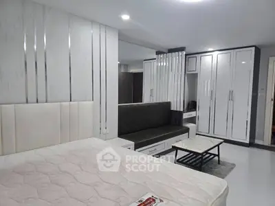 Modern bedroom with sleek white furniture and stylish decor