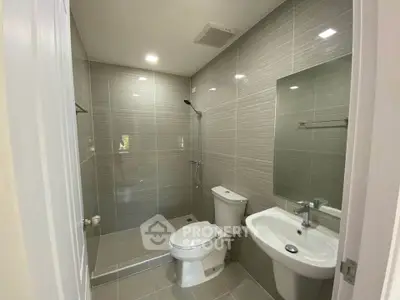Modern bathroom with sleek gray tiles and contemporary fixtures