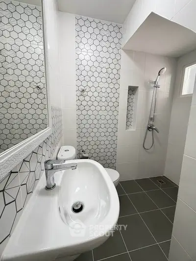 Modern bathroom with stylish hexagonal tiles and sleek fixtures