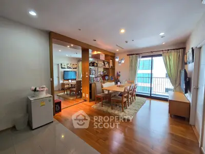 Spacious living room with dining area and balcony view in modern apartment