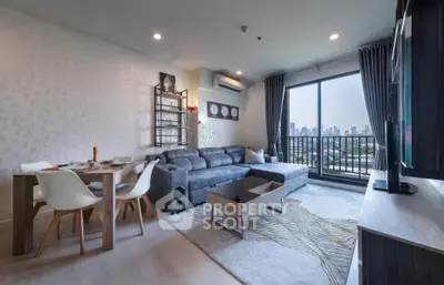 Modern living room with city view, stylish furniture, and large windows for natural light.