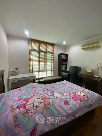 Cozy bedroom with vibrant decor and ample natural light