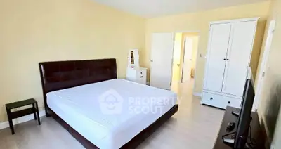 Spacious bedroom with modern furniture and natural light