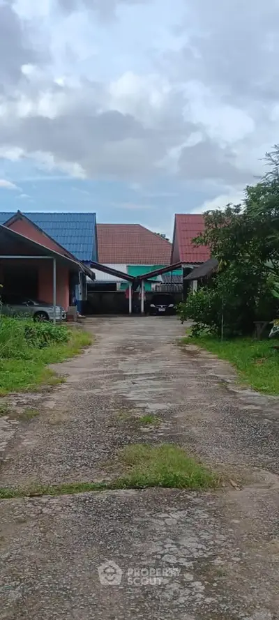 Charming suburban homes with colorful roofs and a spacious driveway.