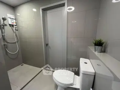 Modern bathroom with sleek design and shower area in contemporary home.