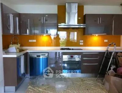 Modern kitchen with sleek cabinetry, stainless steel appliances, and vibrant backsplash