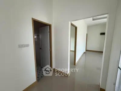 Spacious hallway with modern design and tiled flooring in a contemporary home.