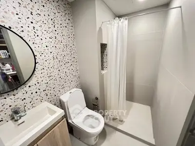 Modern bathroom with terrazzo wall and sleek shower design