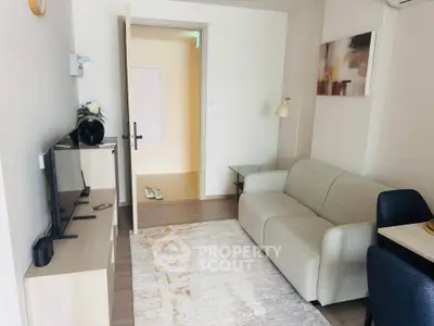 Modern living room with stylish furniture and decor, featuring a cozy sofa and wall-mounted TV.