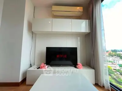 Modern living room with sleek white furniture and large window offering scenic city view.