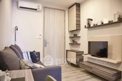 Modern living room with sleek furniture and wall-mounted TV in stylish apartment.