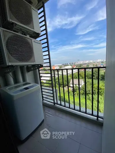 Compact balcony with washing machine and scenic city view
