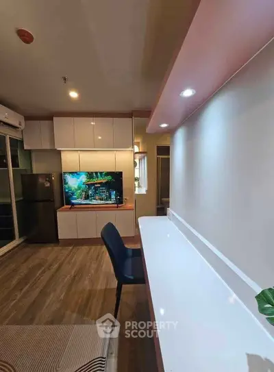 Modern living room with sleek furniture and built-in TV unit, perfect for urban living.