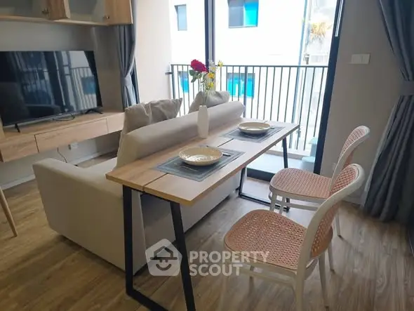 Modern living room with stylish dining area and balcony view