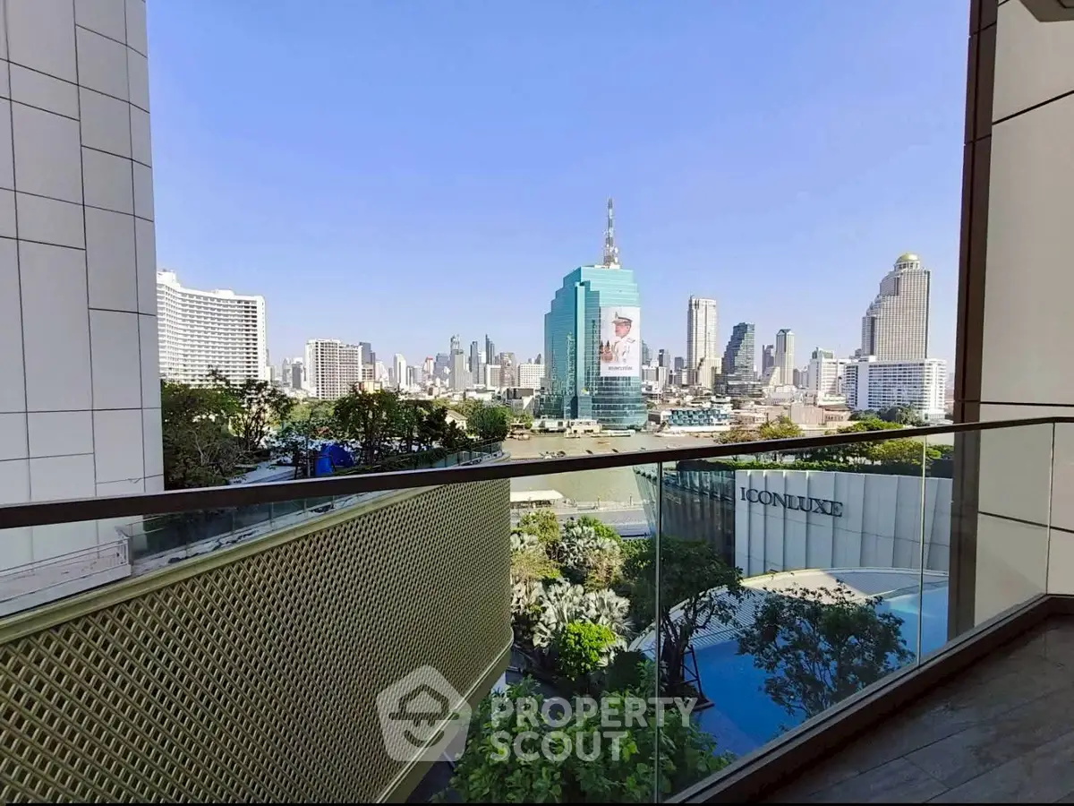 Stunning cityscape view from a modern balcony with glass railing, showcasing urban skyline.