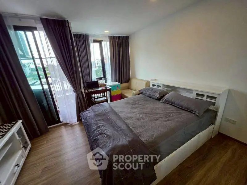 Modern bedroom with balcony access and stylish furnishings