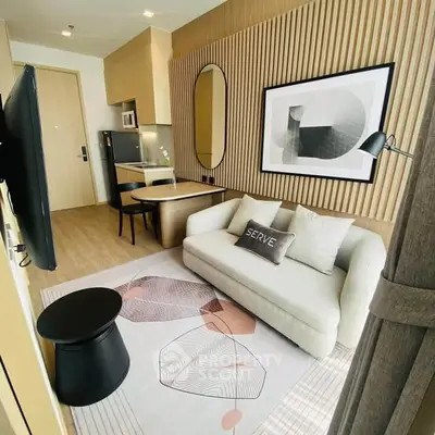Modern living room with stylish decor, featuring a cozy sofa, wall art, and a sleek TV setup.