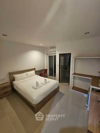 Spacious modern bedroom with minimalist design and natural light