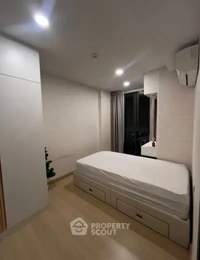 Cozy minimalist bedroom with built-in storage and natural light
