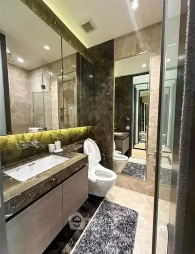Luxurious modern bathroom with elegant marble finishes and sleek fixtures.