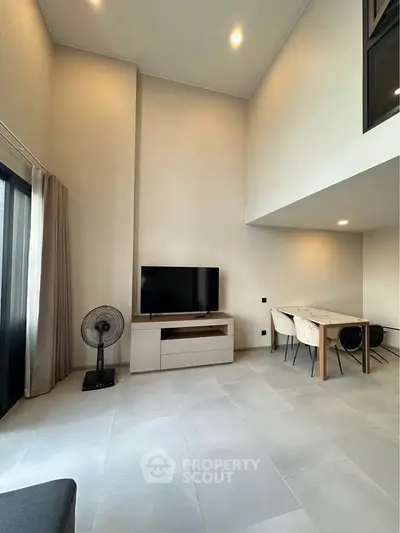 Spacious modern living room with high ceiling and elegant decor