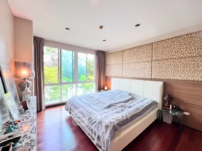 Spacious bedroom with large window and elegant decor