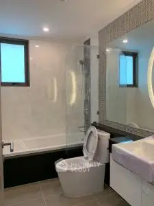 Modern bathroom with elegant fixtures and large mirror in luxury apartment.
